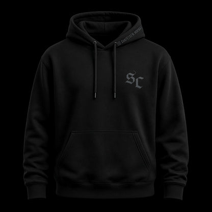 Black Shapecrew hoodie with dark gunmetal SC monogram on the chest, front view