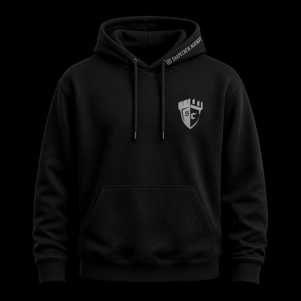 Black Shapecrew Strength & Honour hoodie, front view with a grey castle-shield SC crest on the left chest and SHAPECREW.NORWAY along the hood edge